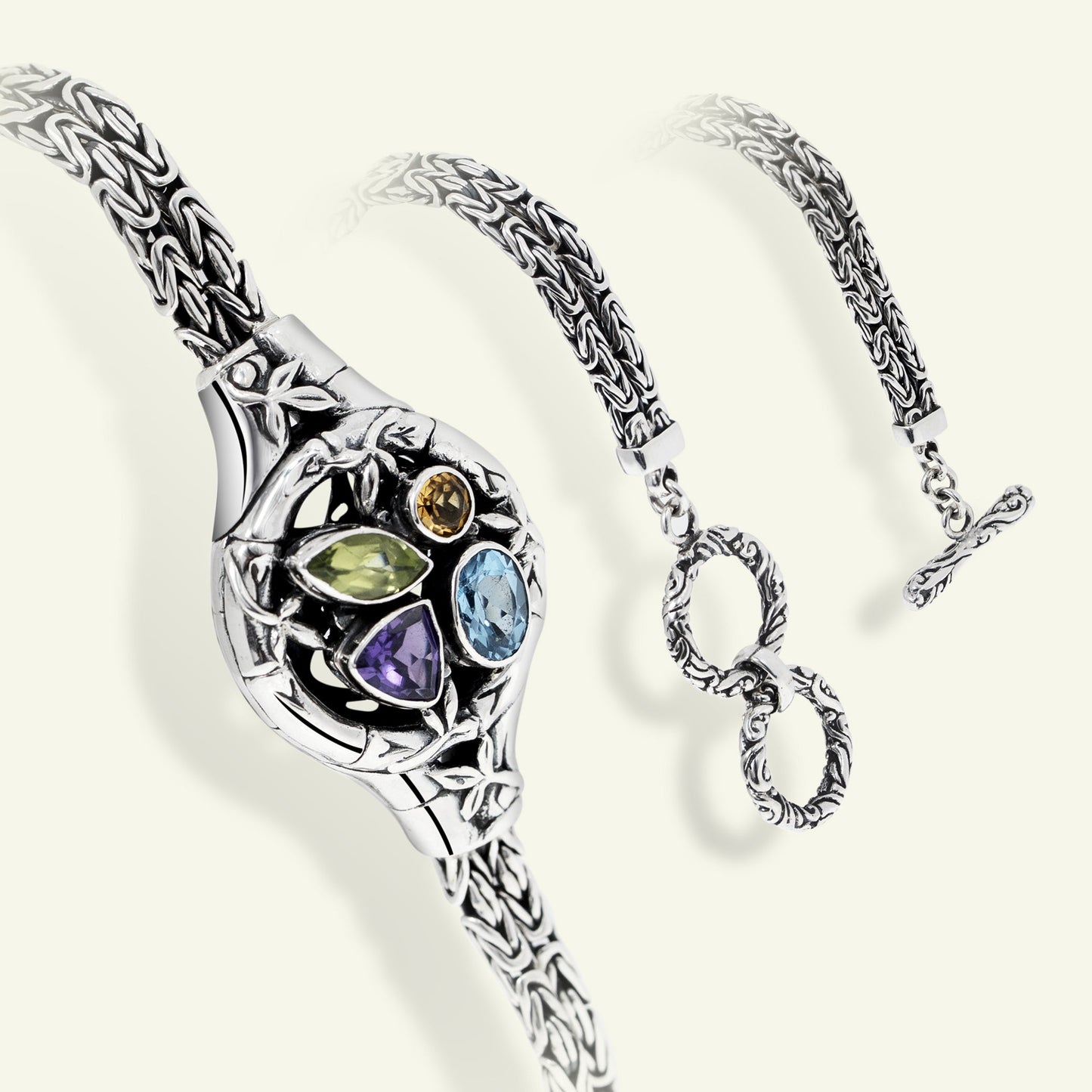 Silver bracelet with gemstones on a white background