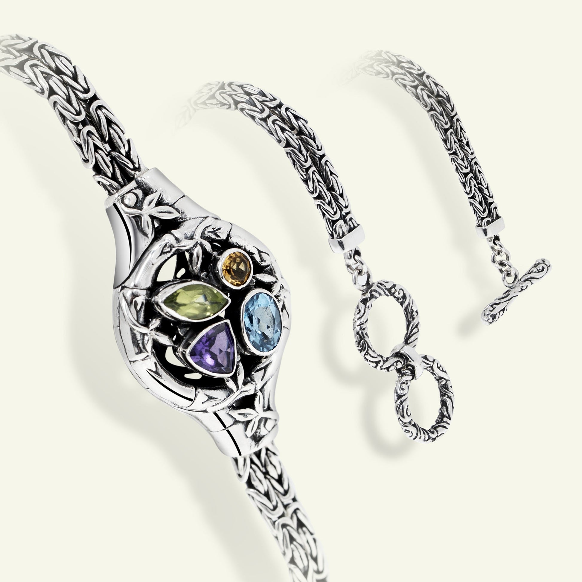 Silver bracelet with gemstones on a white background