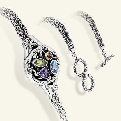 Silver bracelet with gemstones on a white background