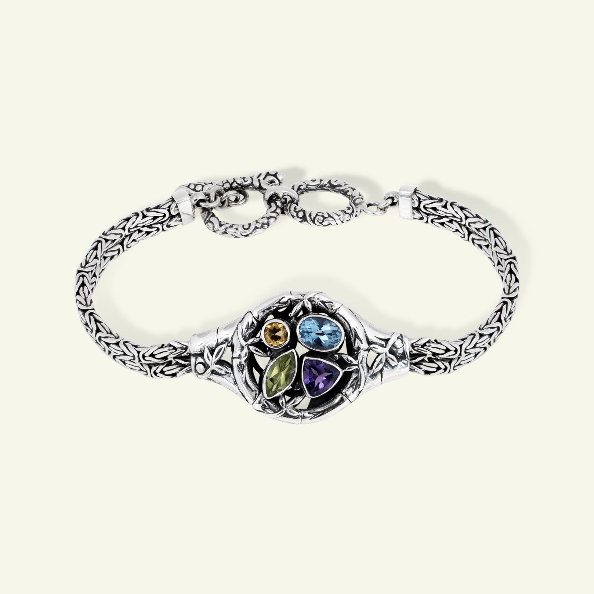 Silver bracelet with colorful gemstones on a white background