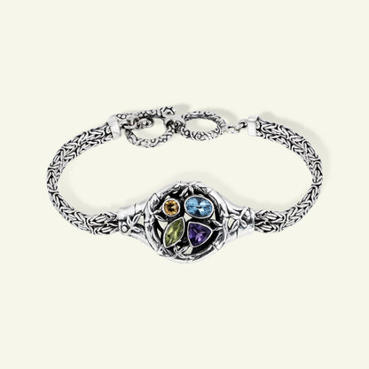 Silver bracelet with colorful gemstones on a white background