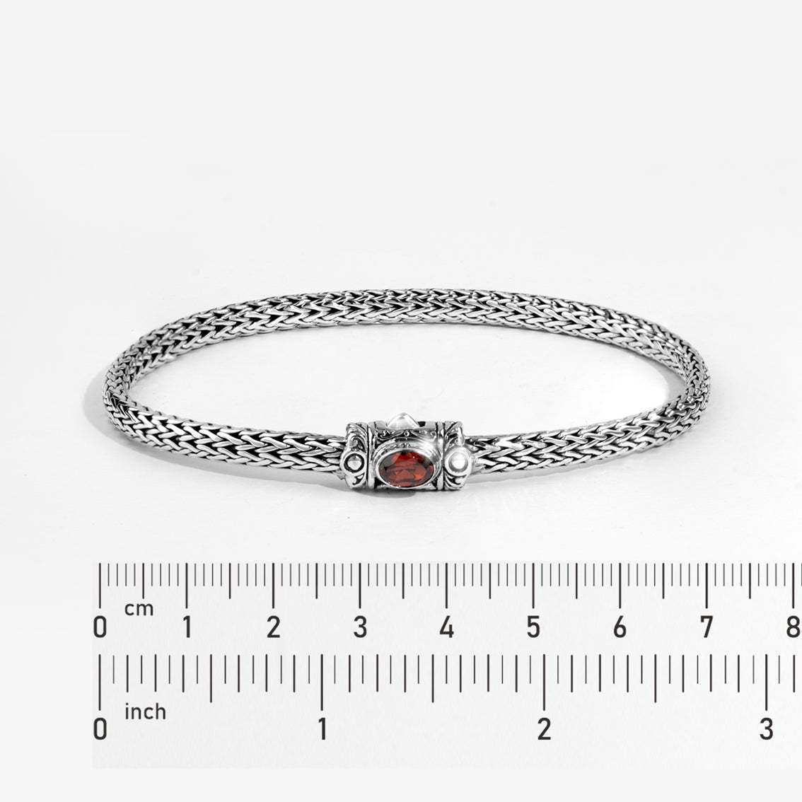 Handwoven Silver Bracelet with Red Gemstone Accent