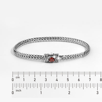 Handwoven Silver Bracelet with Red Gemstone Accent