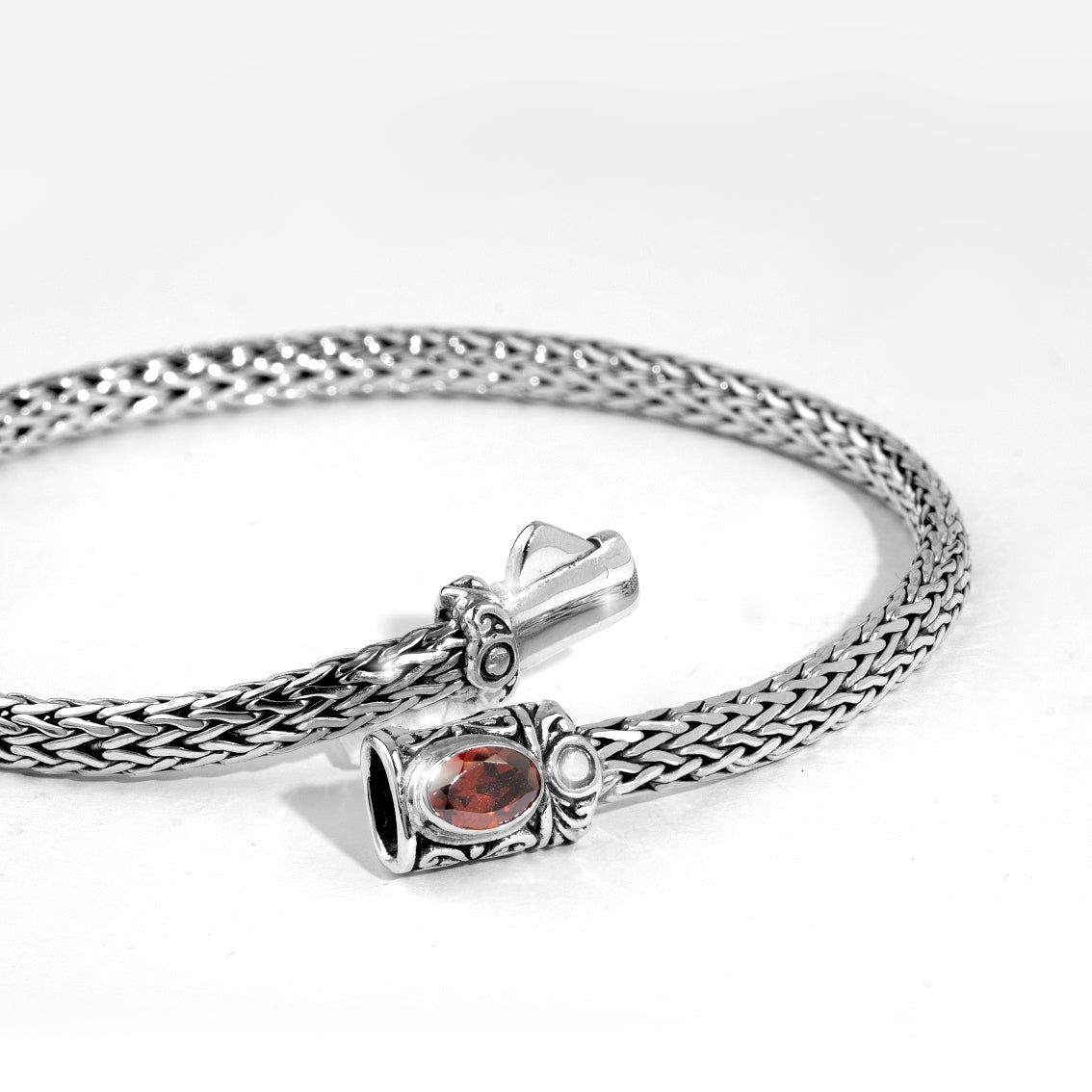 Handwoven Silver Bracelet with Red Gemstone Accent