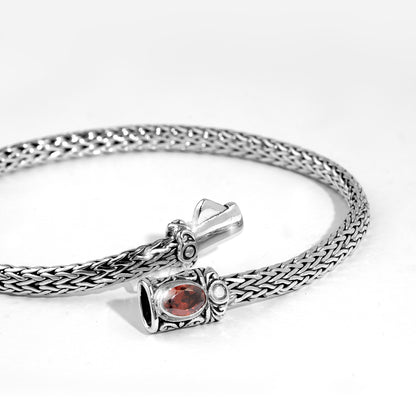 Handwoven Silver Bracelet with Red Gemstone Accent